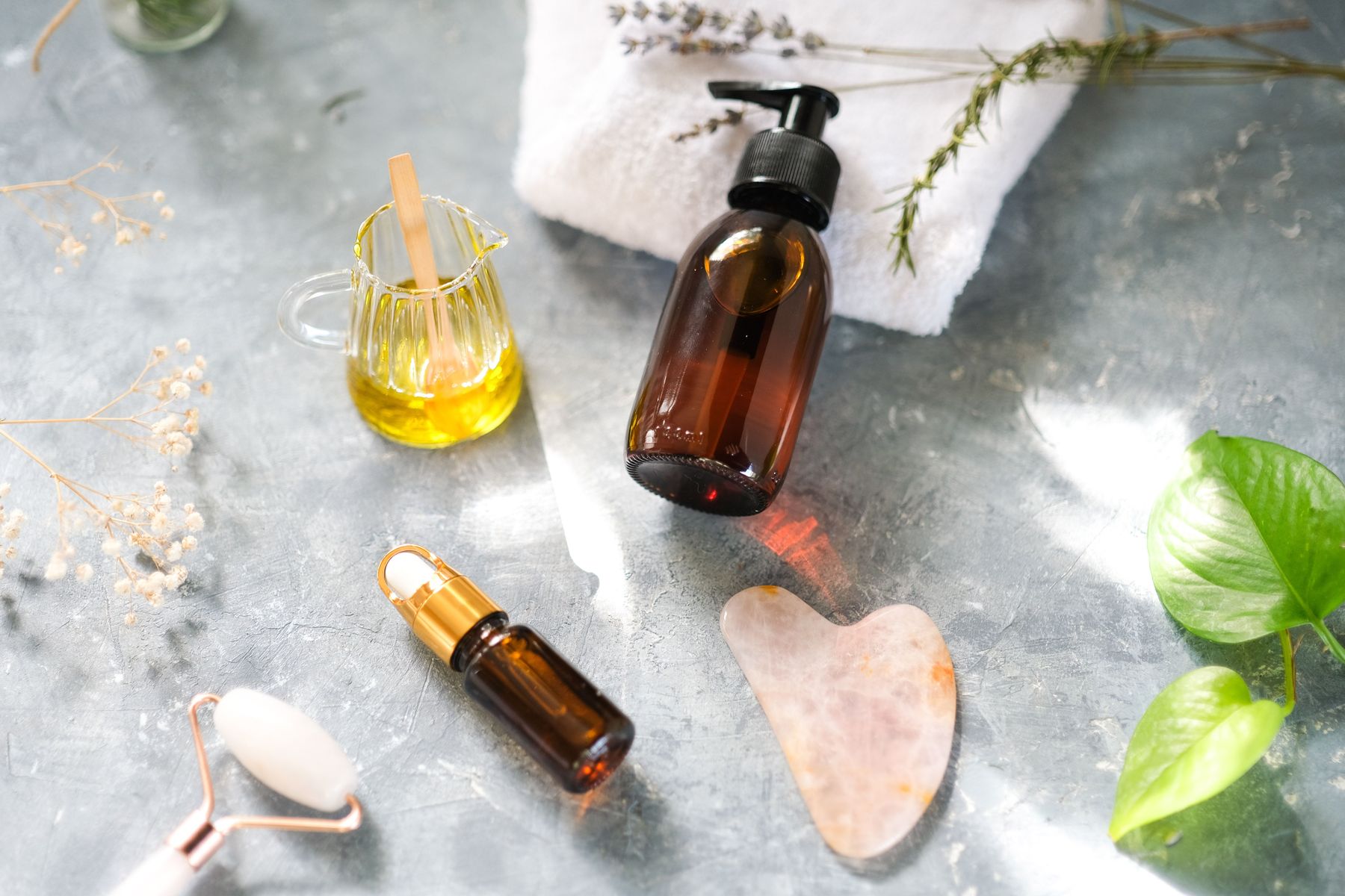 Massage oils, stones and fresh towels arranged for a treatment