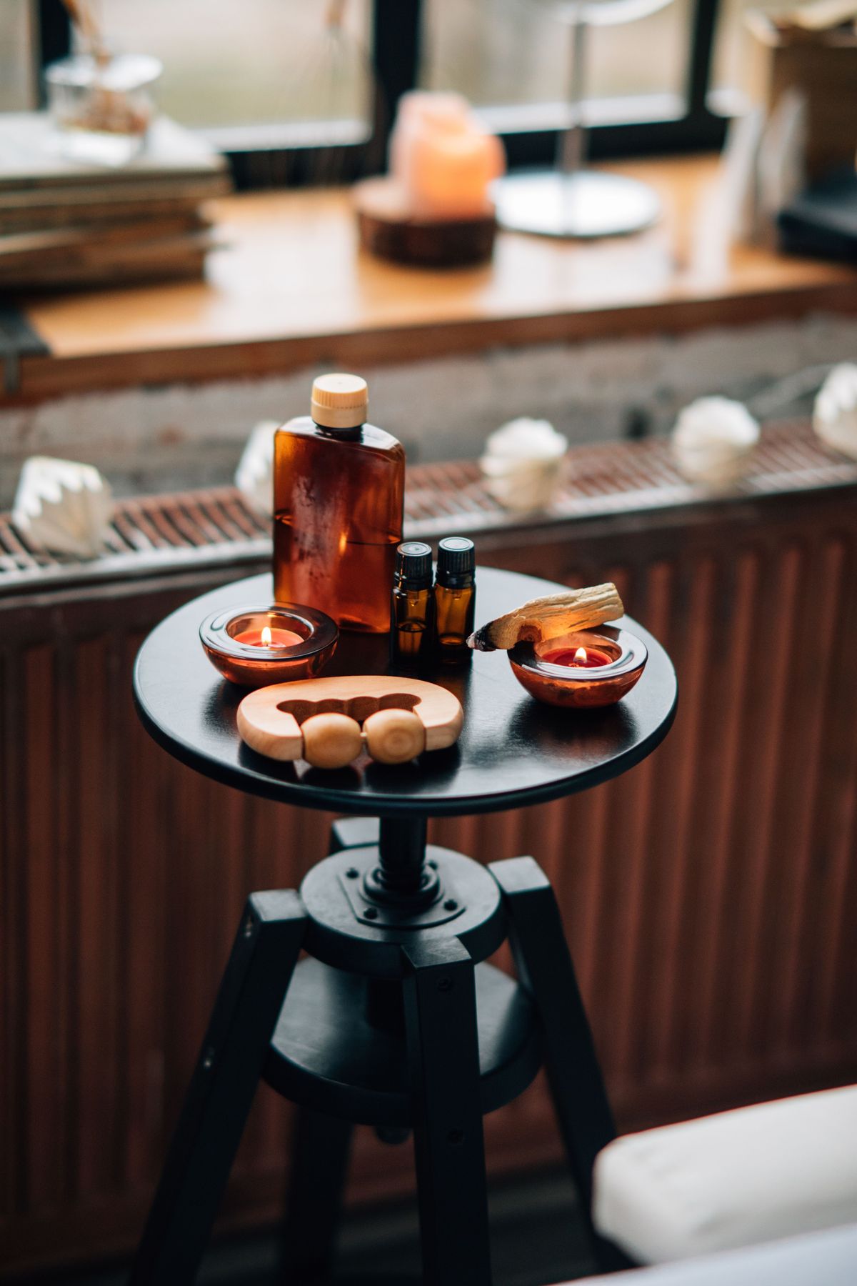 Amber massage oils and candlelight on a treatment side table